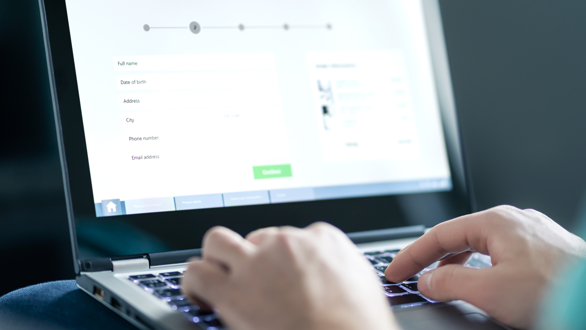 User completes a multi-step web form on a laptop using the keyboard.