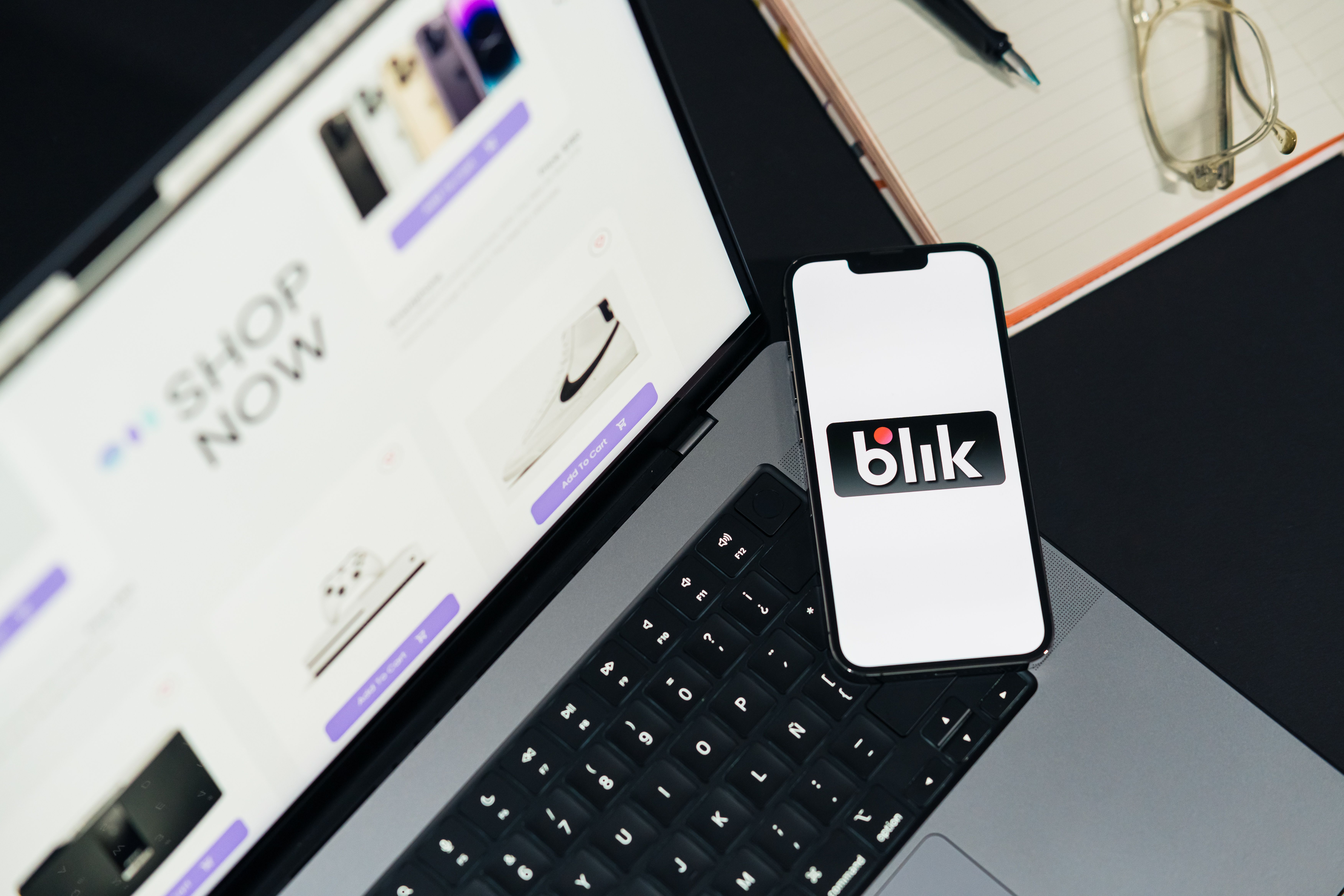 Shopify product page accessibility and mobile shopping Laptop and smartphone displaying online shopping interfaces on a desk, illustrating e-commerce product page accessibility.