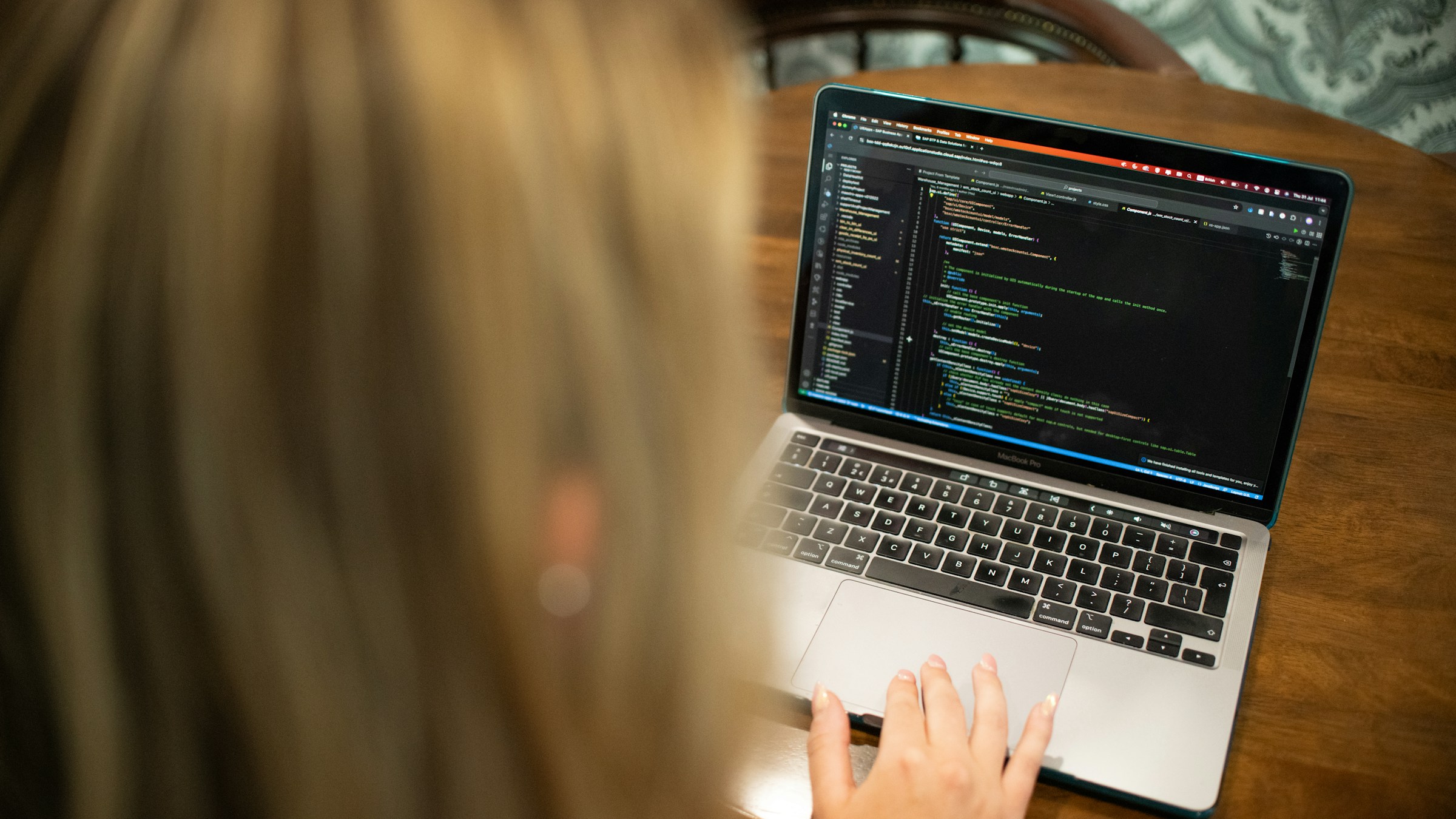 Developer reviews web code on a laptop during a structured accessibility evaluation.