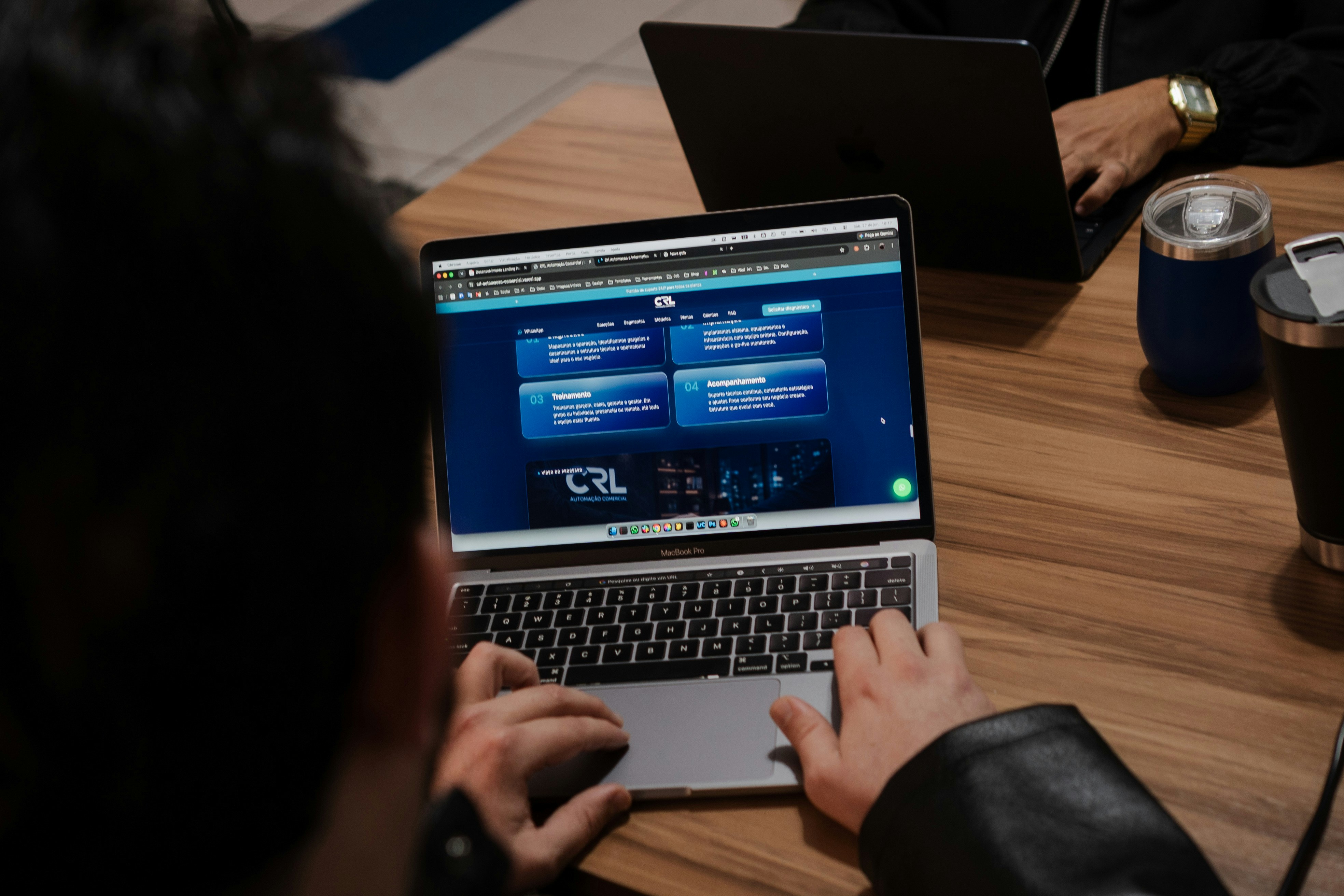 Hands type on a laptop displaying a web interface during hands-on accessibility review.