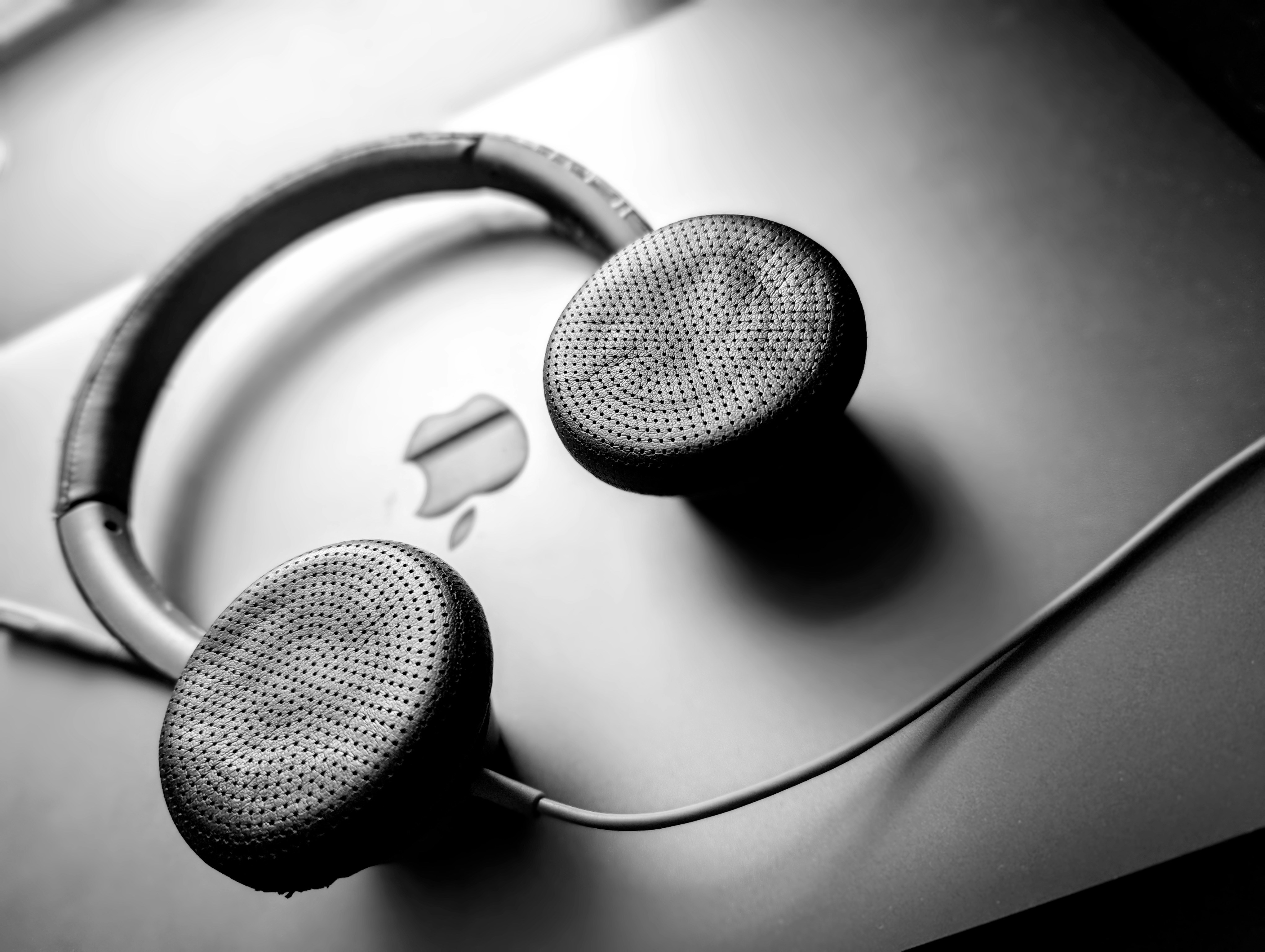 Headphones rest beside a computer keyboard in a focused digital workspace.