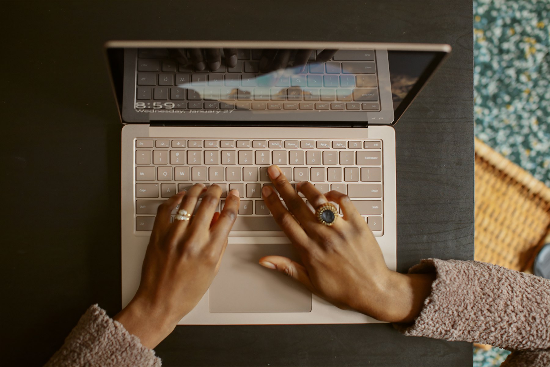 Person uses a laptop keyboard during a hands-on software product review.