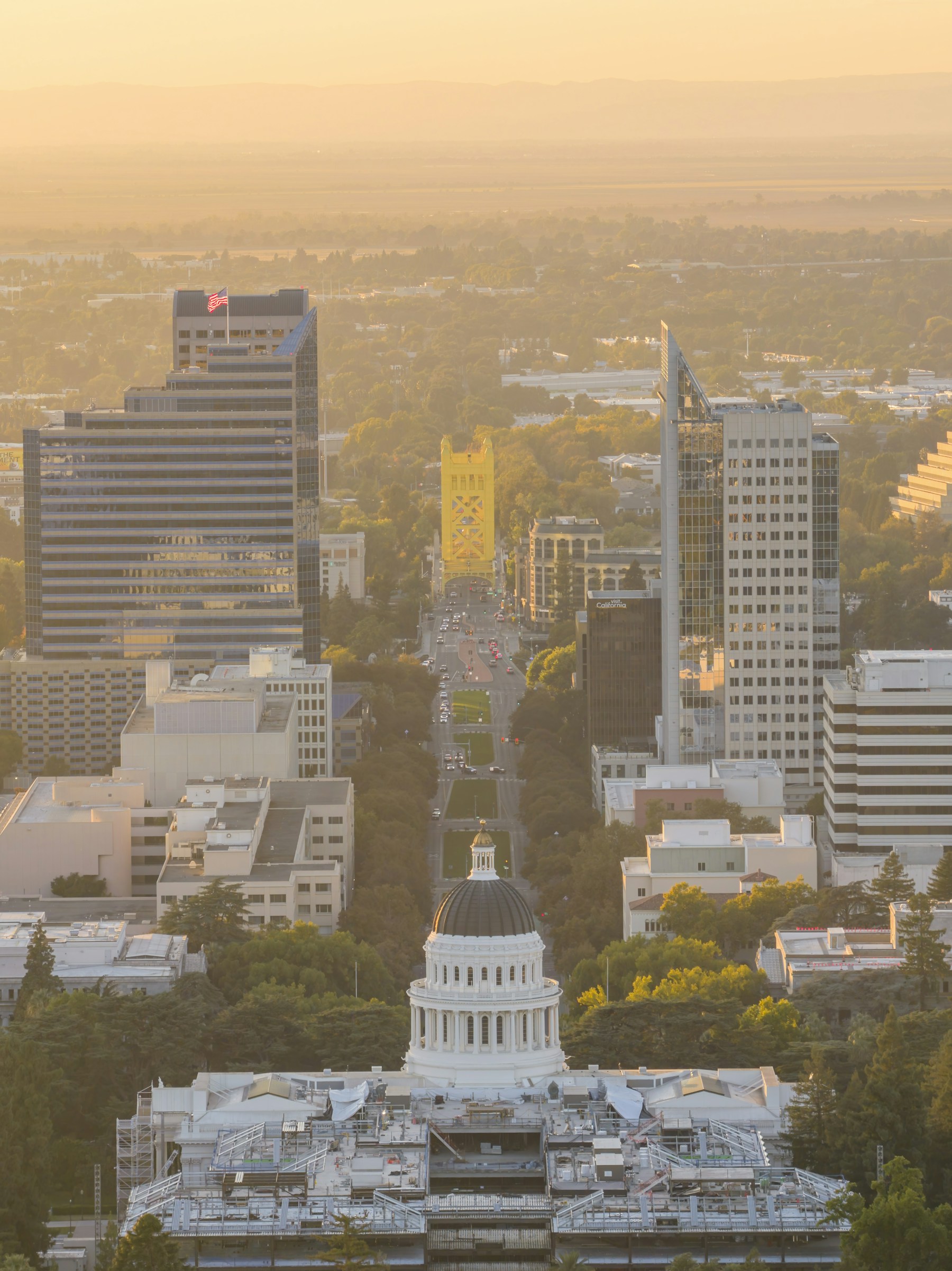 Sacramento skyline surrounds the California State Capitol during golden hour.