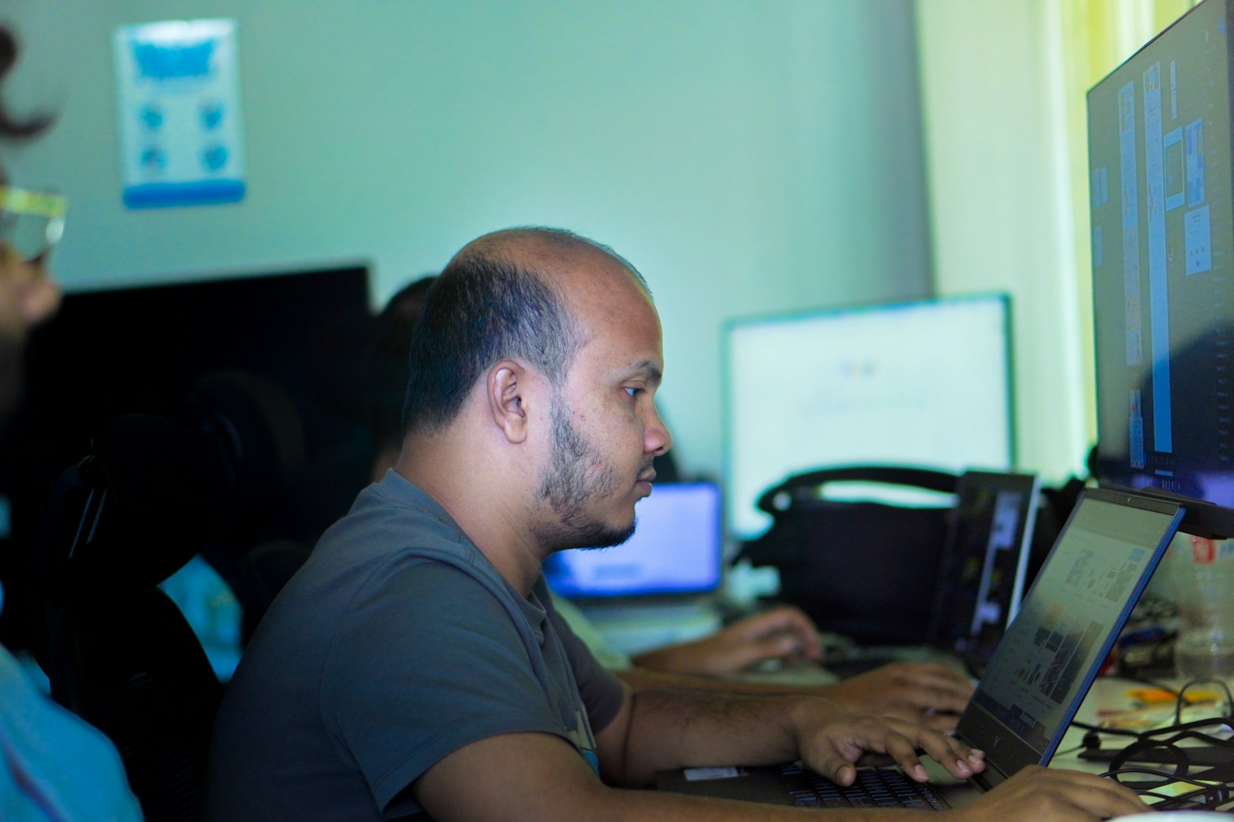 Web developer works on a laptop while reviewing a digital product for accessibility.