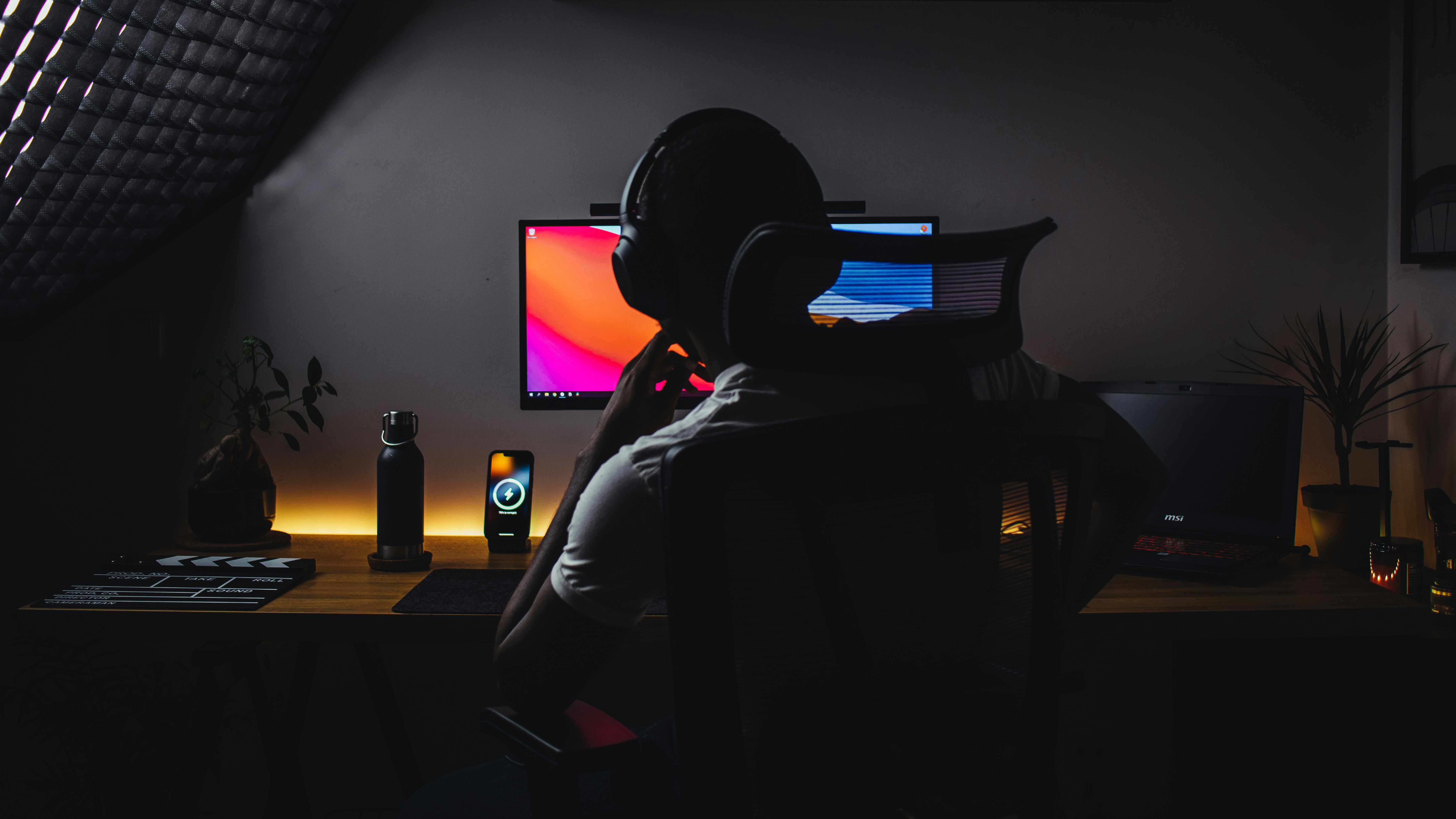 Computer user wearing headphones works at a desktop during a screen reader accessibility testing session.